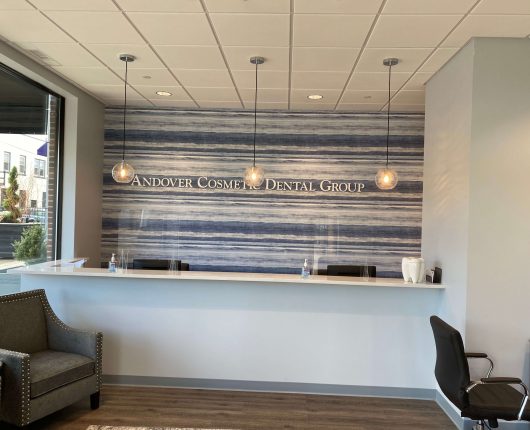 Andover Cosmetic Dental Group logo on the wall